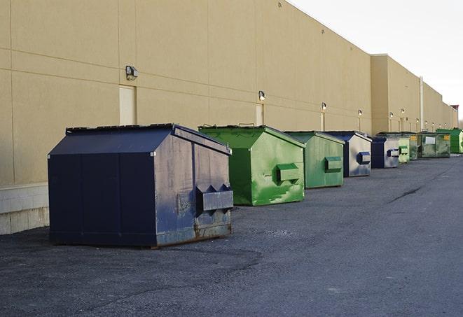 a fleet of red and blue construction dumpsters available for use in Barnesville MN